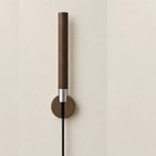 The Chaser held in its walnut Cradle, wall-mounted